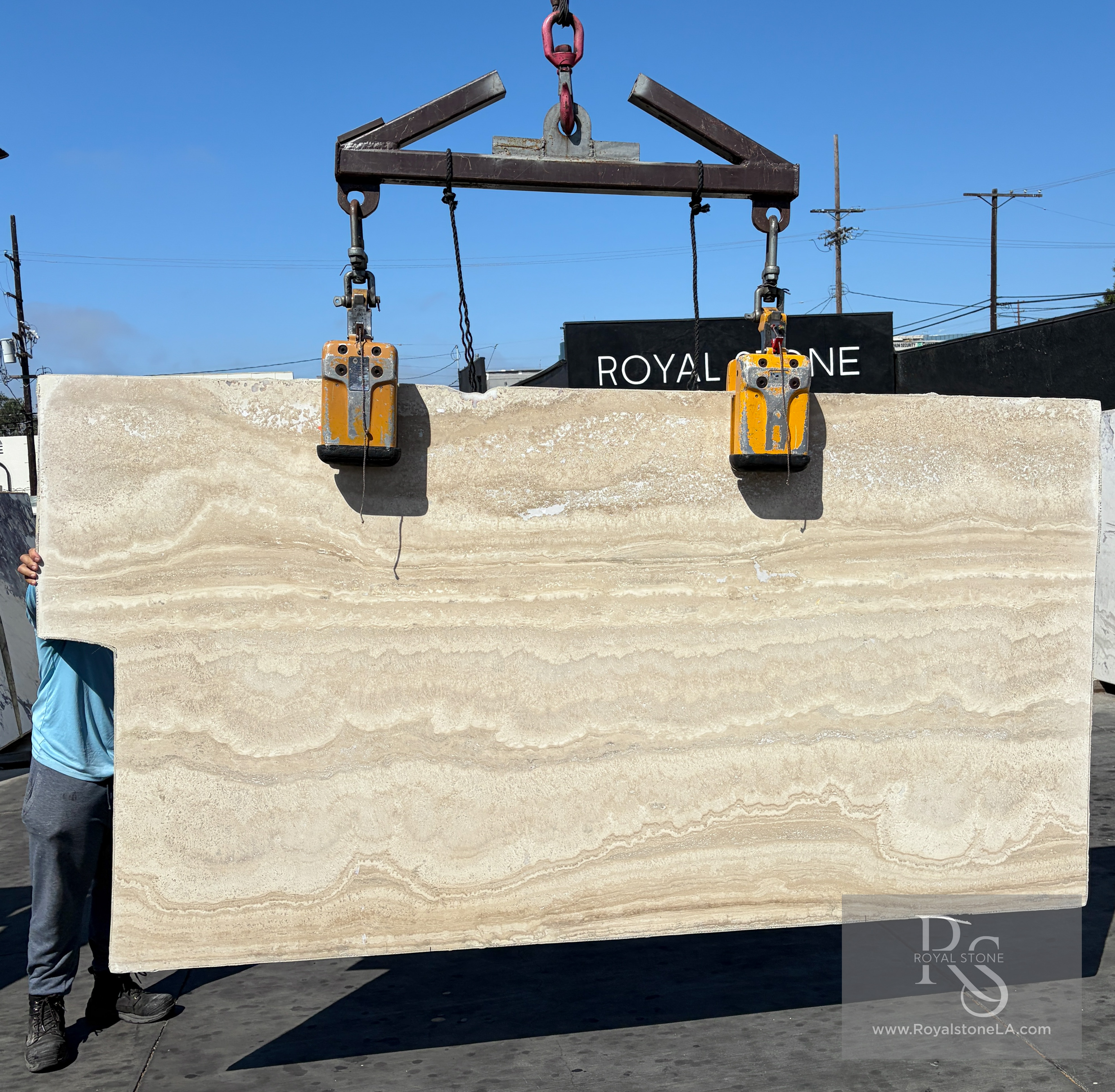 2cm Italian ivory travertine vein-cut filled and honed slab, 57 by 106 inches, lifted on vacuum clamps at Royal Stone Los Angeles