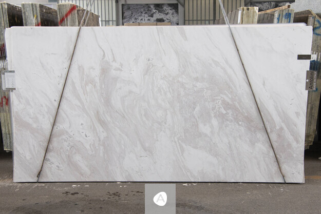Calacatta Cremo marble slab with soft cream field and quiet taupe-gray swirl, polished