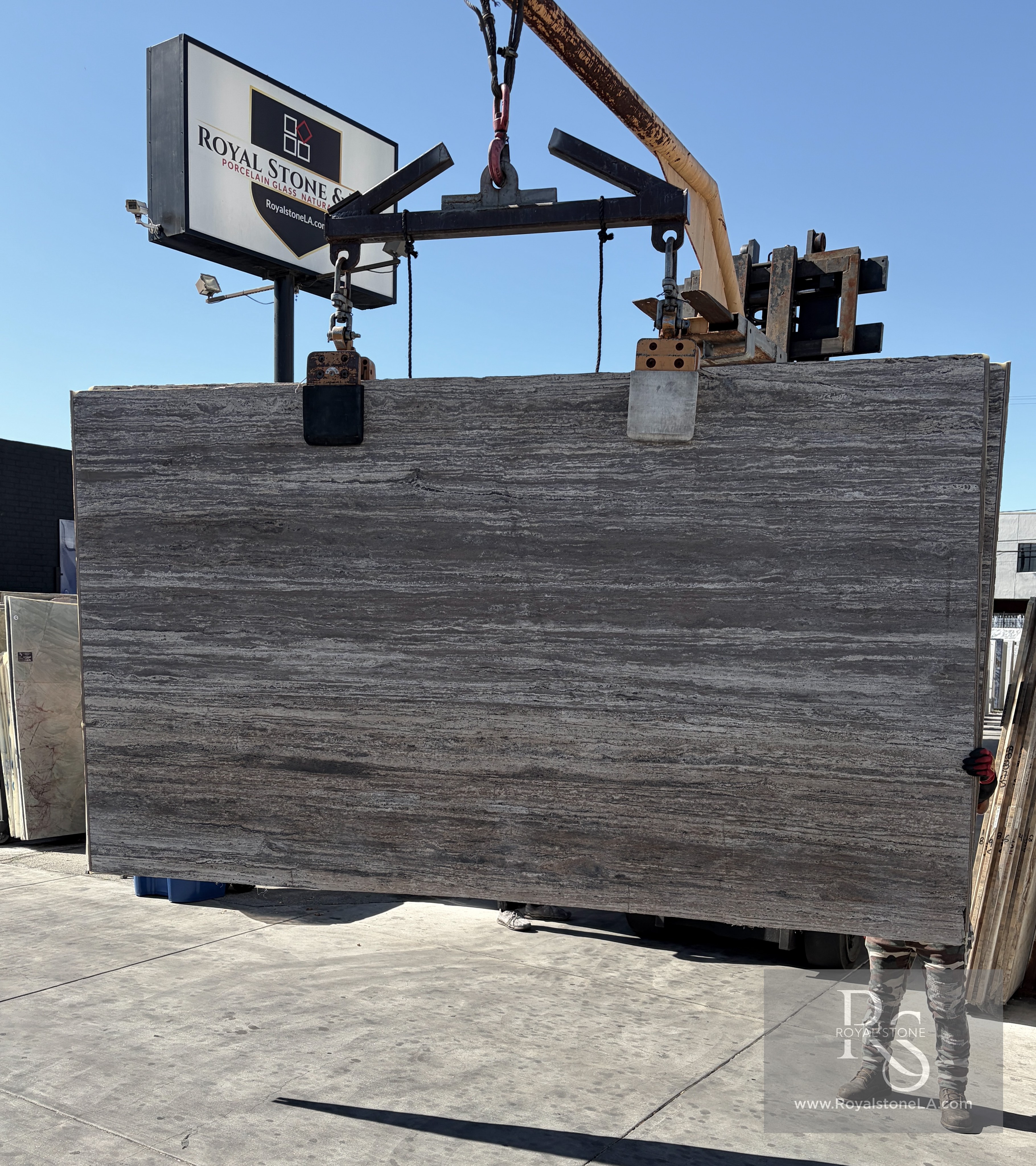 Travertino Titanium honed and filled travertine slab at Royal Stone, cool gray field with faint cream and taupe banding