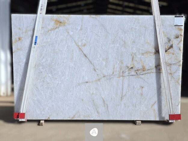 Antolini Cristallo Lumix quartzite slab with translucent white field shot with warm gold filaments, polished