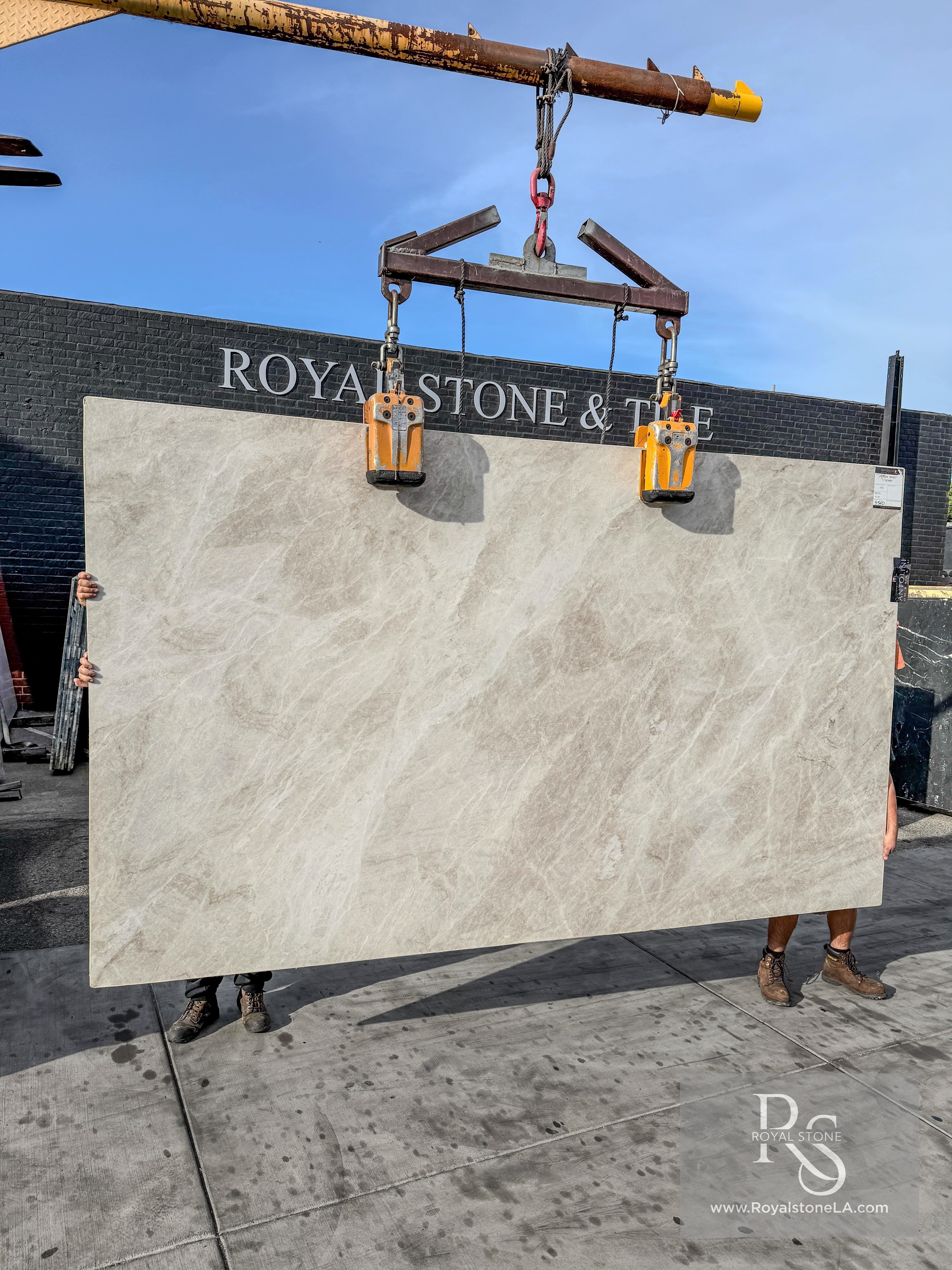 Taj Mahal quartzite slabs from the March 2026 container at Royal Stone, warm ivory field with soft beige banding