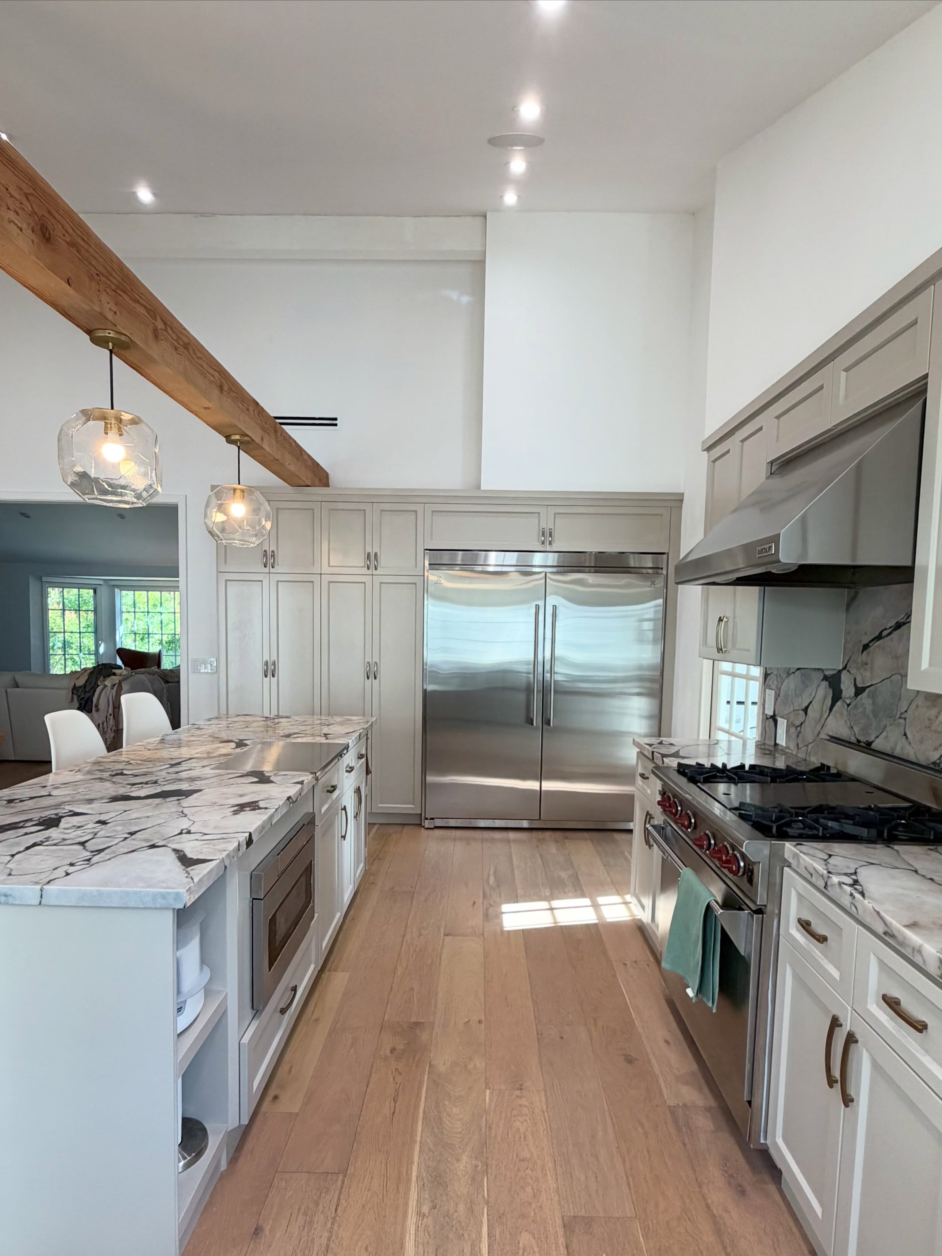 Spacious kitchen with a large island and countertops made from dramatic Calacatta Viola marble.