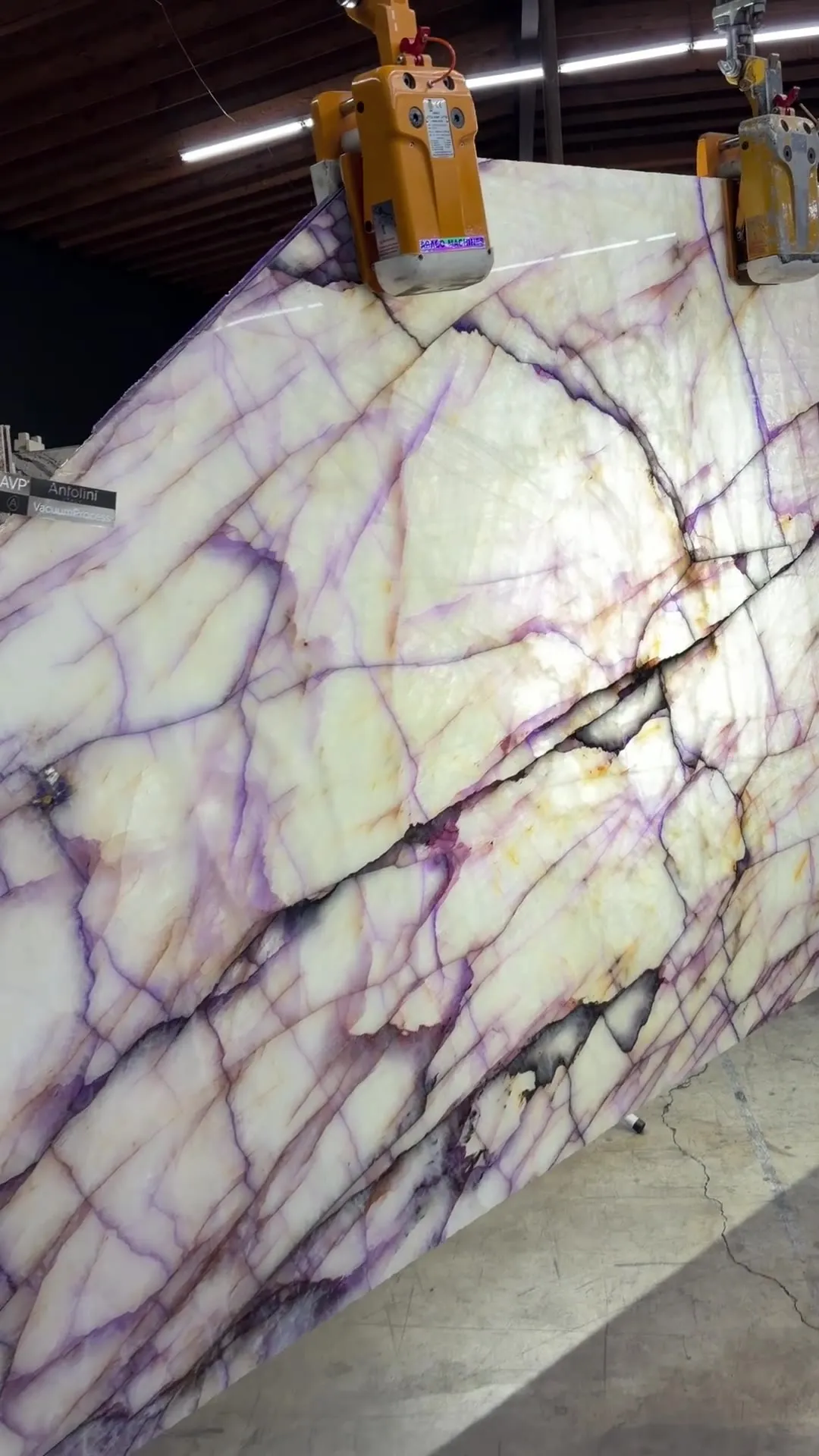 2cm Antolini Cristallo Trasviolet Treated DW654 polished slab, 70 by 102 inches, on the floor at Royal Stone — violet streaks across a translucent white crystalline field